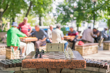 Chess board with pieces and clock on wooden desk In connection with the chess tournament. Chess...