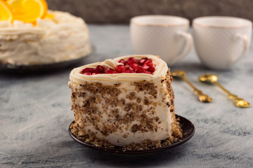 Cake with nuts and pomegranate seeds. Beautiful holiday dessert.