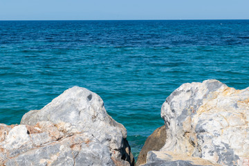seascape on the background of large stones and blue sky