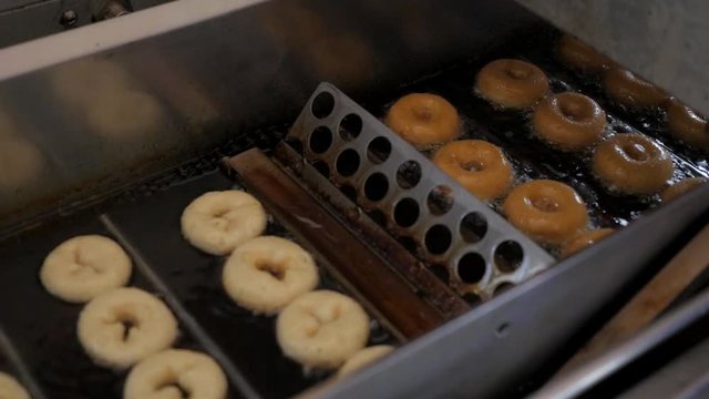 Mini Donut Machine flipping donuts in deep frying oil
