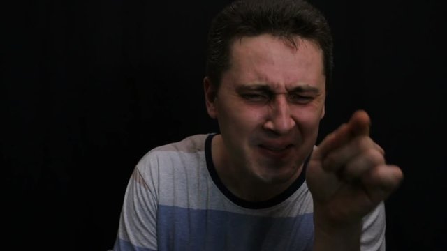 unhappy young handsome caucasian man shows his emotion close-up
