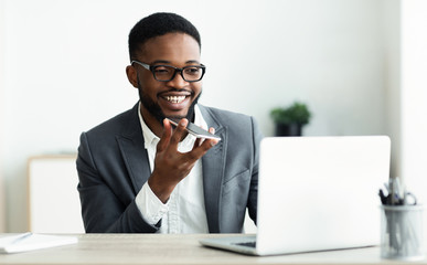 African American businessman using voice assistant on smartphone