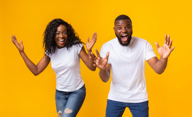 Shocked afro couple with hands wide open