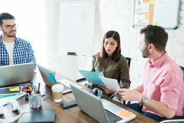 Fototapeta premium Colleagues Planning Over Documents In Office