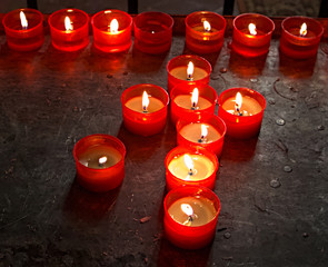Burning candles in a church in Bologna. Italy