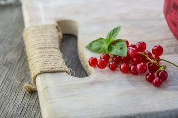 Fresh red currant on wooden background. Close up photo of the fresh berries. Harvest Concept