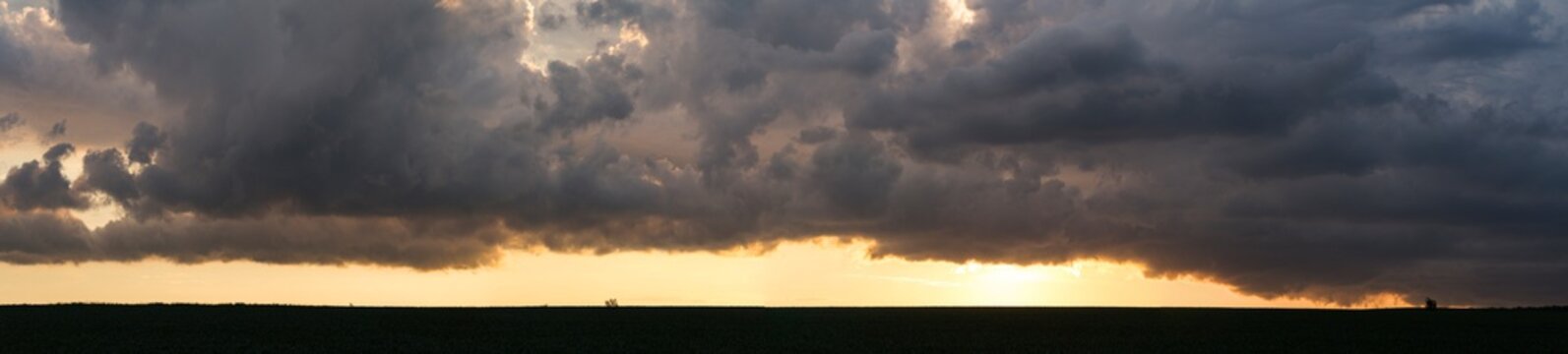 Leaden, storm clouds covered the sunset. Cumuliform cloudscape on blue sky. The terrain in southern Europe. Fantastic skies on the planet earth. Tragic gloomy sky.	