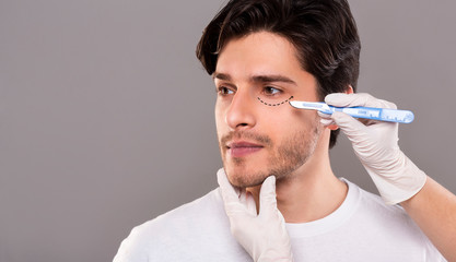 Handsome male face with black marks on skin under eye