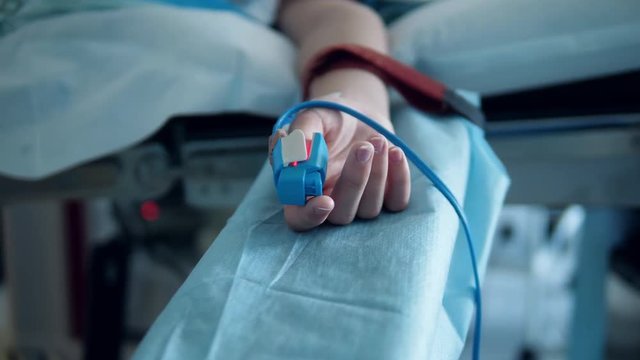 Patient under anesthesia lying on a surgical table.