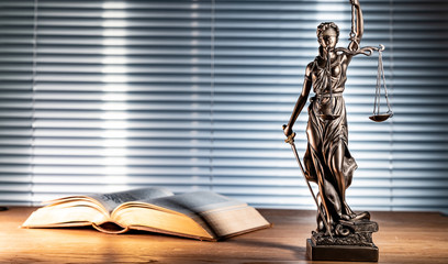 Statue of lady justice on bright background - Side view with copy space.