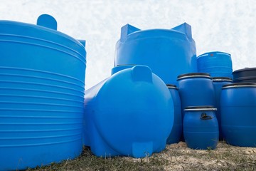 Various polyethylene tanks displayed outdoors.