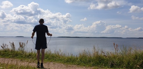 Mature man jumping rope. Man jumping rope in nature.