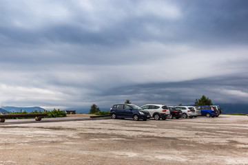 Cars parking under alpine mountain in Austria