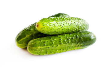 small pile of fresh cucumbers on a white background, green eco-friendly homemade cucumbers isolate