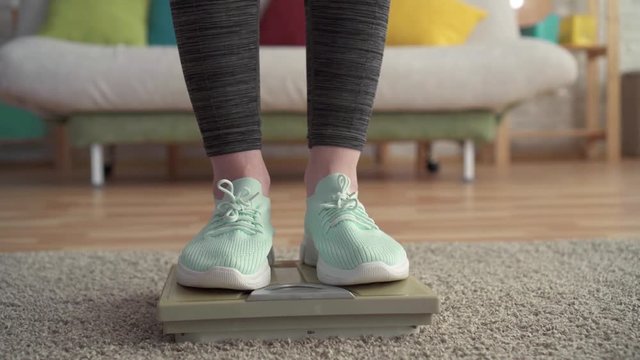 Weight control concept,women's feet on the floor scales