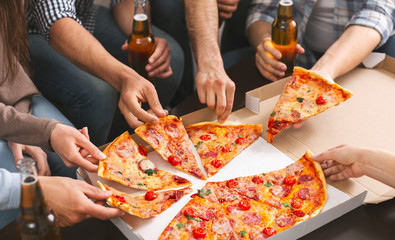 Group of friends sharing pizza together at home party