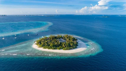 Zelfklevend Fotobehang Aerial view of beautiful island at Maldives in the Indian Ocean. Top view from drone. © gawriloff