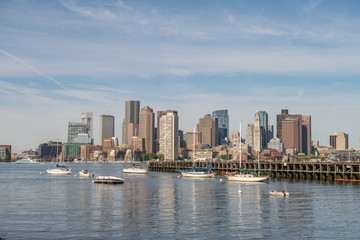 Fototapeta premium View of Multiple Sail Boats Docked in the Ocean With Downtown Boston in the background