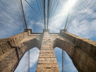 Looking Up one of the Brooklyn Bridge Towers With Sun Flare on the side