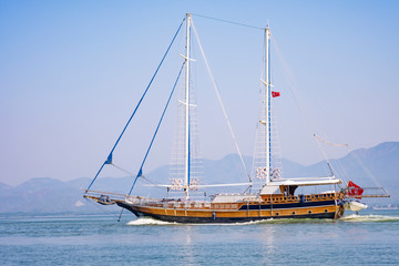 Sailboat in the sea in the morning light on the background of beautiful big mountains,Summer adventures, outdoor activities in the Mediterranean sea, Turkey
