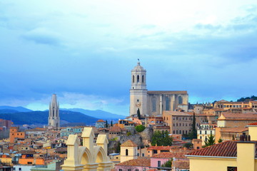 Fototapeta na wymiar View of Girona Spain from the Medieval Wall Surronging the City, the Two Largest Church Cathedrals can be Seen off in the Distance