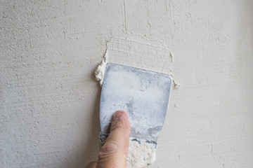 Putty the wall with an old spatula.