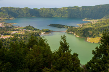Obraz premium Lagoa das Sete Cidades is located on the island of São Miguel, Azores and is characterized by the double coloration of its waters, in green and blue.