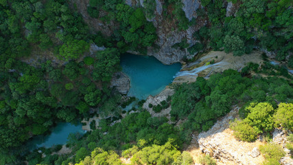 Naklejka na ściany i meble Aerial drone photo of famous mountain lake and waterfall in Polilimnio area in Messinia, Peloponnese, Greece