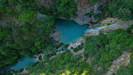 Fototapeta na wymiar Aerial drone photo of famous mountain lake and waterfall in Polilimnio area in Messinia, Peloponnese, Greece