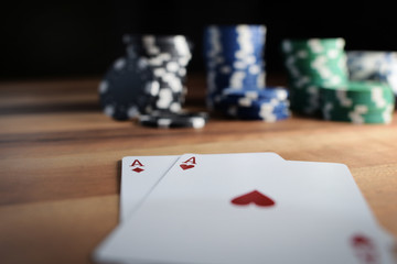 Poker Chips with Playing Cards on a Beautiful Wooden Table