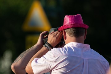 Man in a pink hat mirroring another man