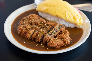Japanese curry rice with fried beef and omelet.