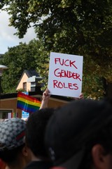 A sign in a Pride parade that says "Fuck gender roles"