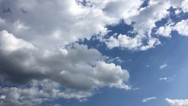 Time lapse video at noon, with the sky bright blue and white.  Beautiful cloud movement during the day in very hot weather.  Sky weather time lapse video with cloudy weather suitable for background.