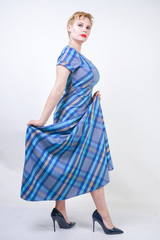 cute plus size blonde girl in a long rustic plaid blue dress