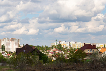 Fototapeta premium Outskirts of Chisinau. Panorama with the capital of Moldova. Cloudy sky before the rain. 