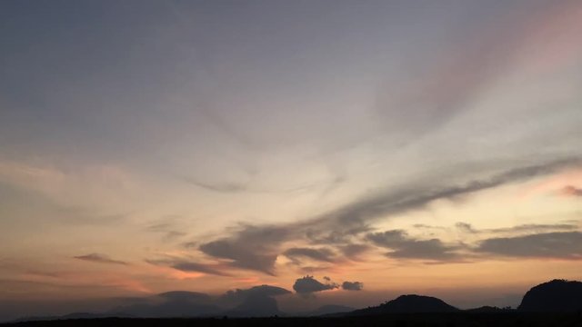 Time lapse video at sunset, with the sky blue, orange and red. Beautiful cloud movement from late afternoon to night. Sky weather time lapse video with cloudy weather suitable for background.