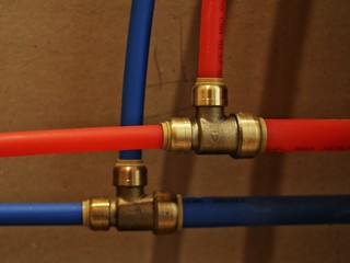 Sharkbite fittings with red and blue PEX pipe.