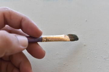 woman hand holding painting brush
