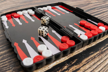 Small pocket backgammon on a wooden table