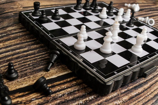 Small pocket chess on a wooden table