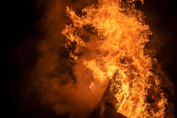 Detailed blazing fire and flames texture against night sky