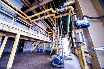 Interior of modern natural oil factory. The piping, pumps and motors