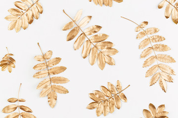 Autumn composition. Autumn golden leaves on white background with a paper white blank card. Flat lay, top view, copy space