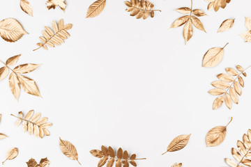 Autumn composition. Frame made of autumn golden leaves on white background. Flat lay, top view,...