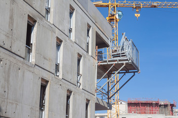Construction site in France of a residential building, with scaffholdings, concrete facades and...