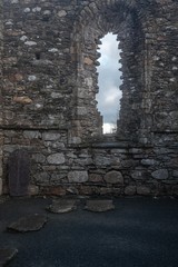 Open long window in an ancient stone building in Ireland