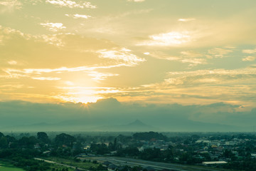 Scenic view of sunset over suburbs houses  against the foggy and mountain at  Nakhon Si Thammarat, Thailand