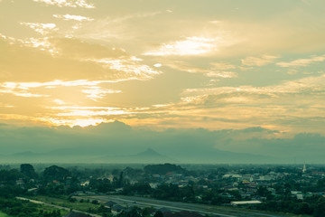 Scenic view of sunset over suburbs houses  against the foggy and mountain at  Nakhon Si Thammarat, Thailand