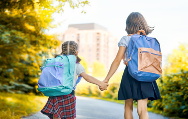 Girls with backpack are going to school